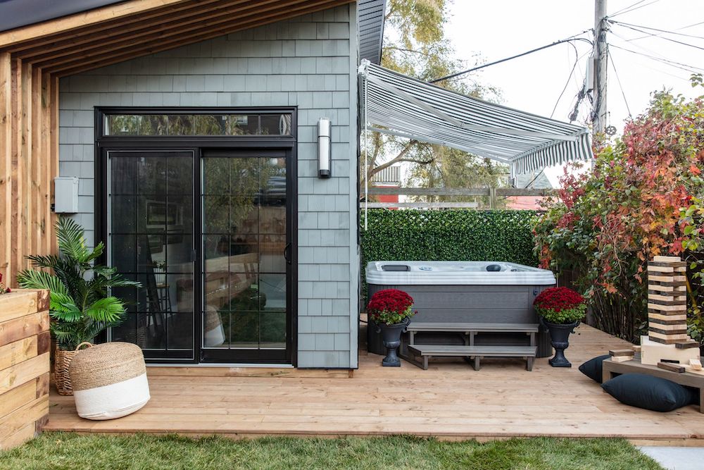 exterior of gym structure with hot tub beside it