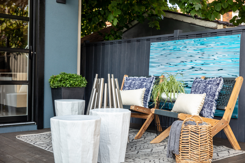 backyard relaxation space with modern silver-tone firepit and lounge chairs