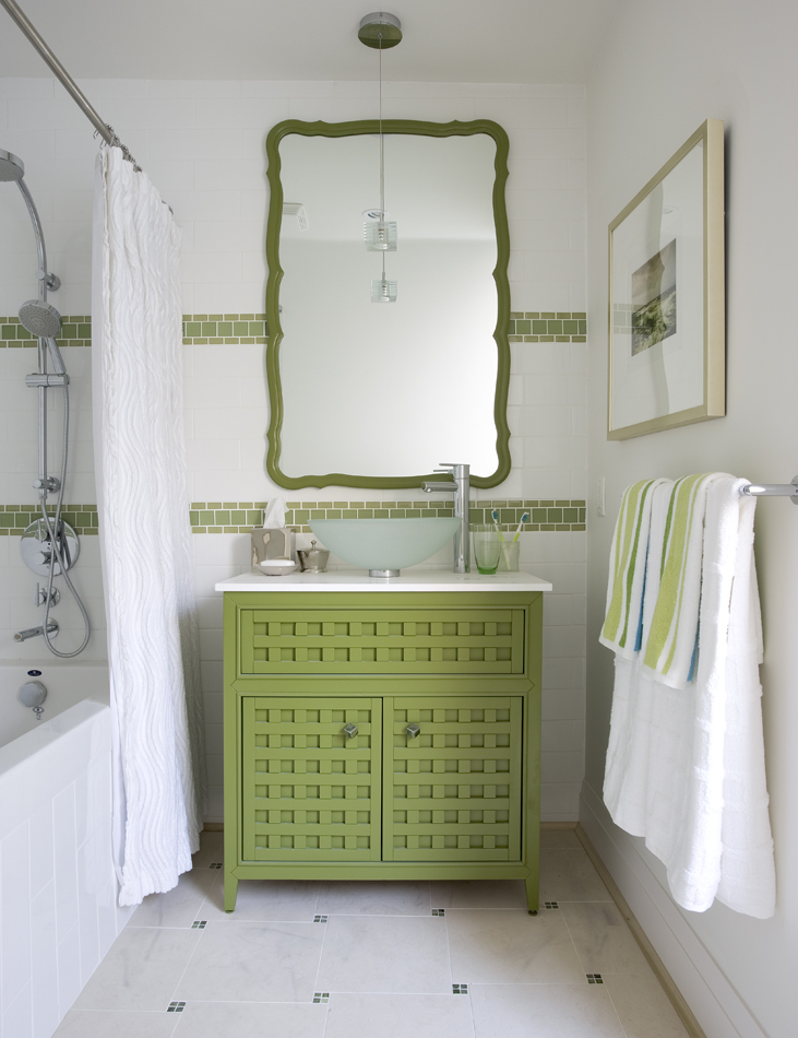 Green and white bathroom with matching mirror and tiles