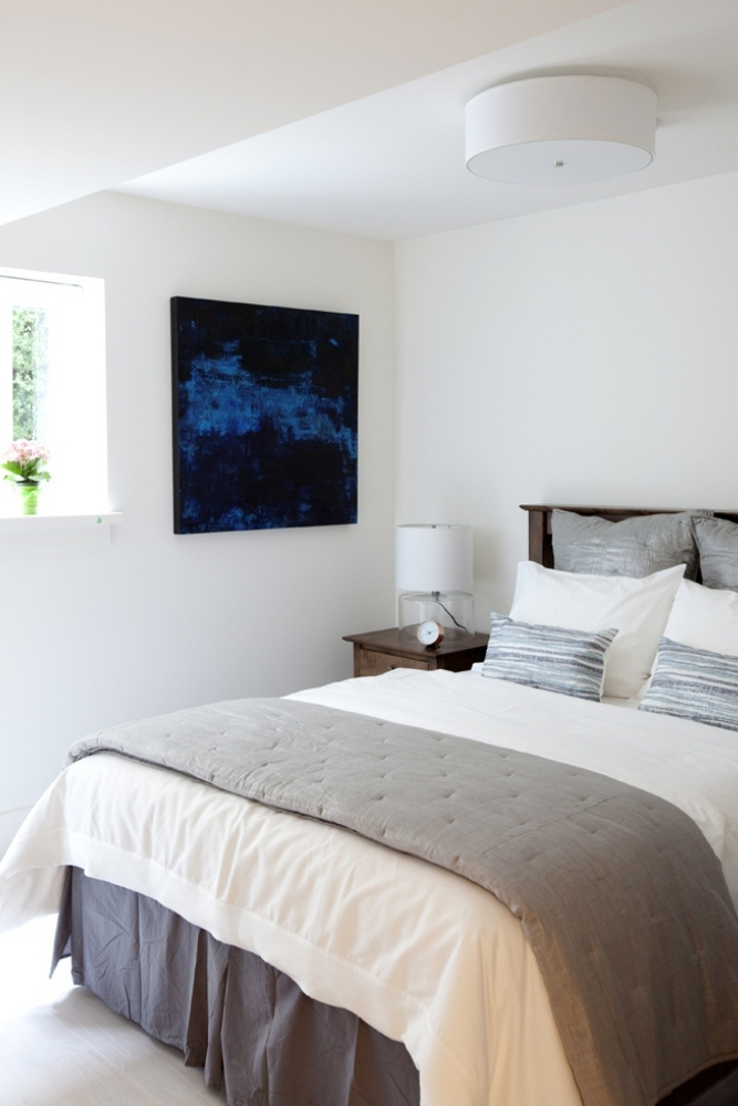 A bright and airy guest bedroom in the basement