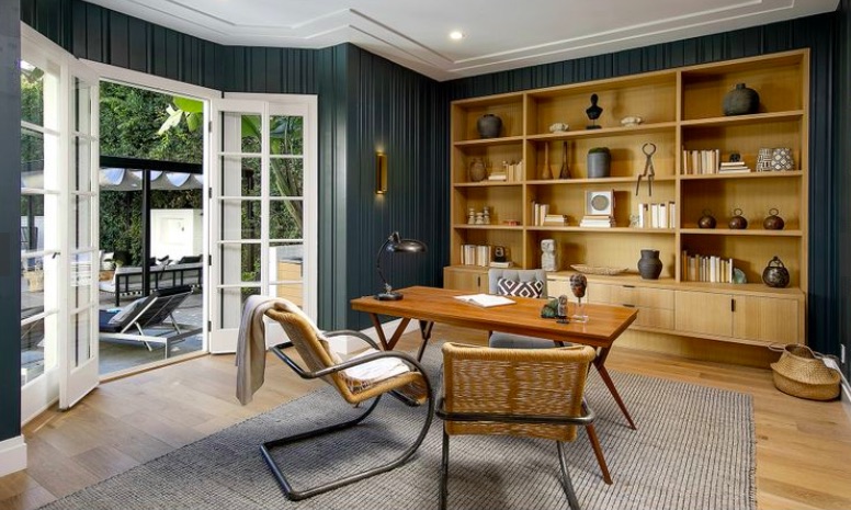 An office with wood-trimmed French doors leading out to the back deck