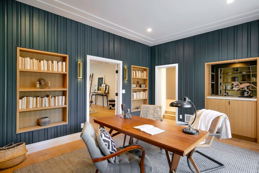 A built-in book case in the mansion's dark blue office/den