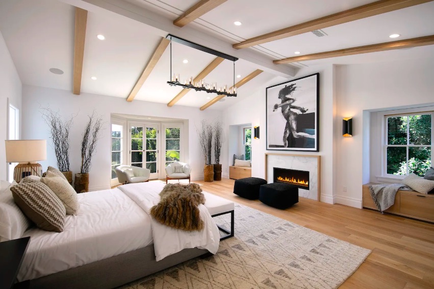 The master bedroom featuring a private terrace and marble fireplace