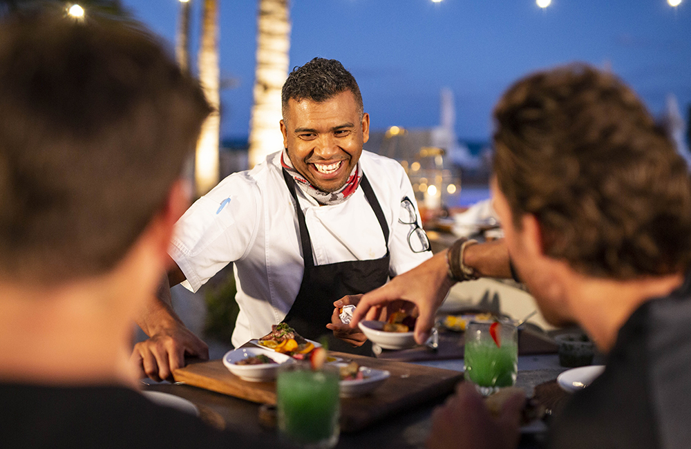 A bartender at the Island of Bryan serving customers.