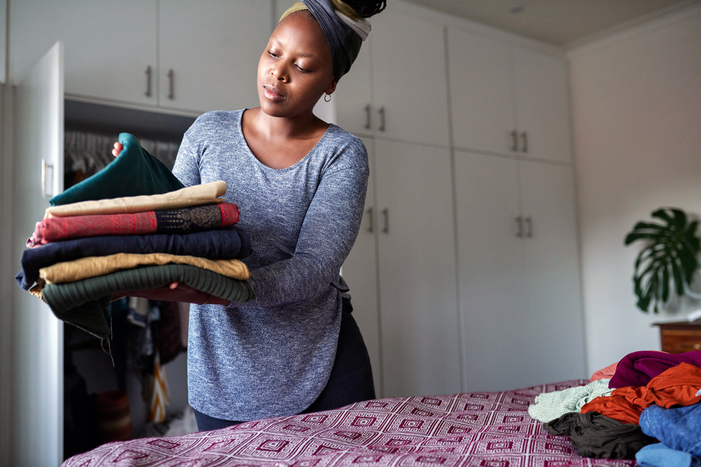 Young woman organizing her room