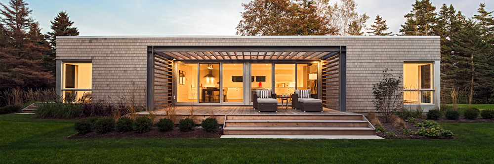 cedar shingle home with windows showing kitchen