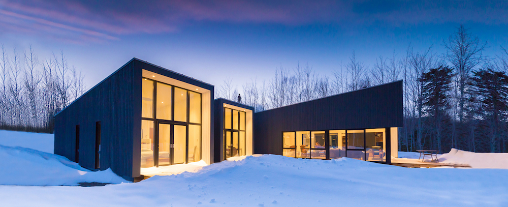 modern prefab house in the snow