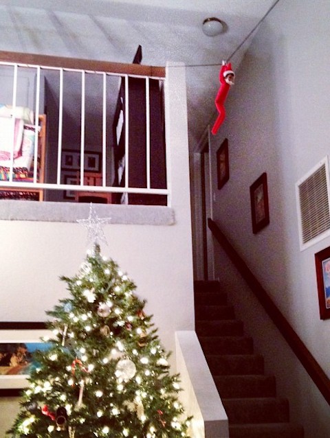 Elf on the shelf flying across a zip line