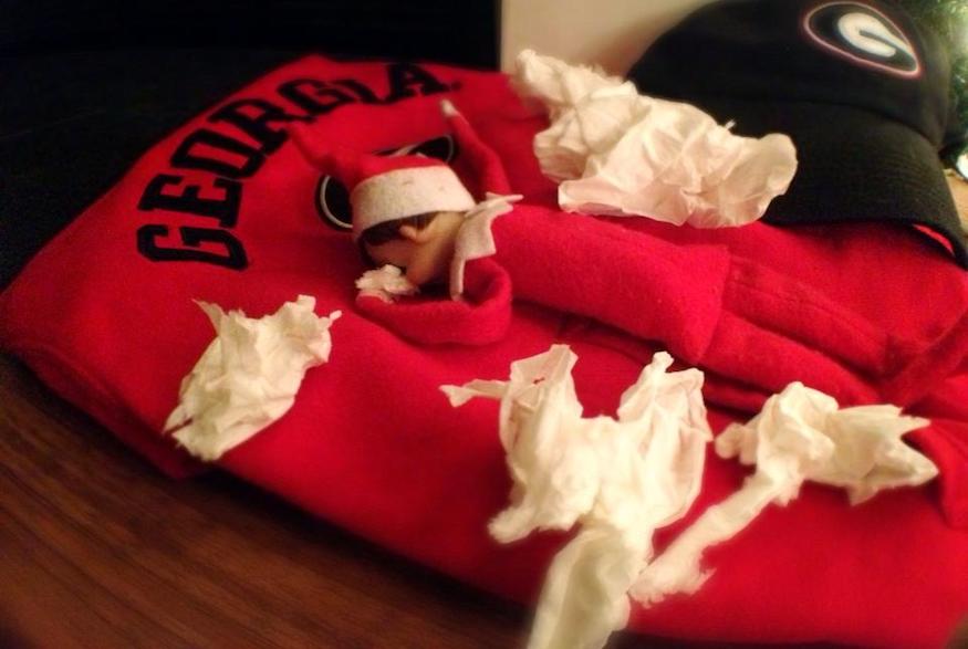 Elf on the shelf crying into a sweatshirt