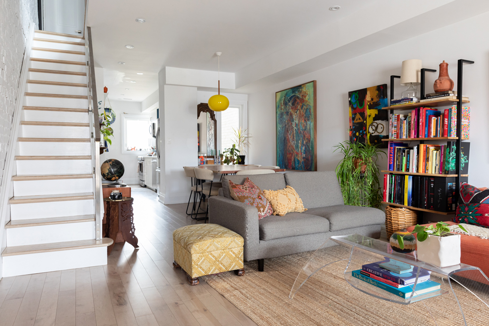 White living room and dining room with colourful wall art