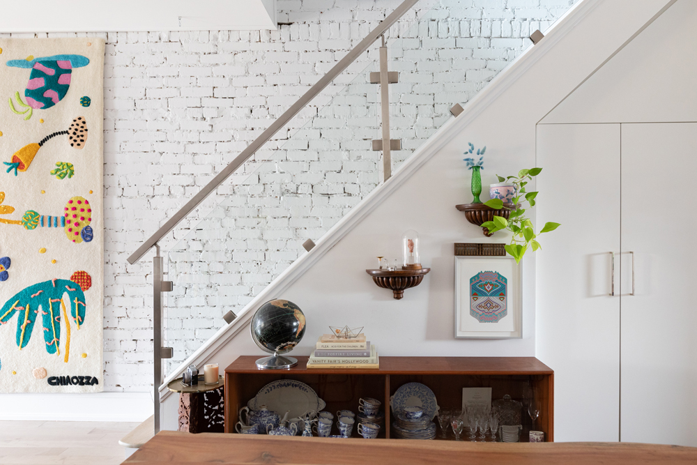 Side view of white staircase with glass railing