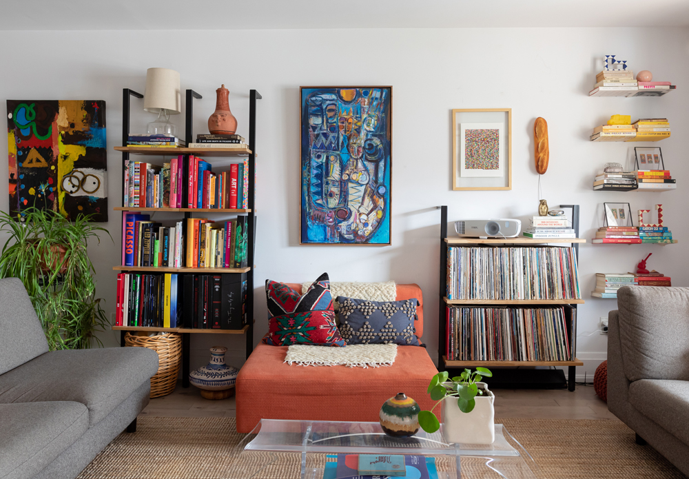 White living room with ladder shelving and vintage treasures on the shelves