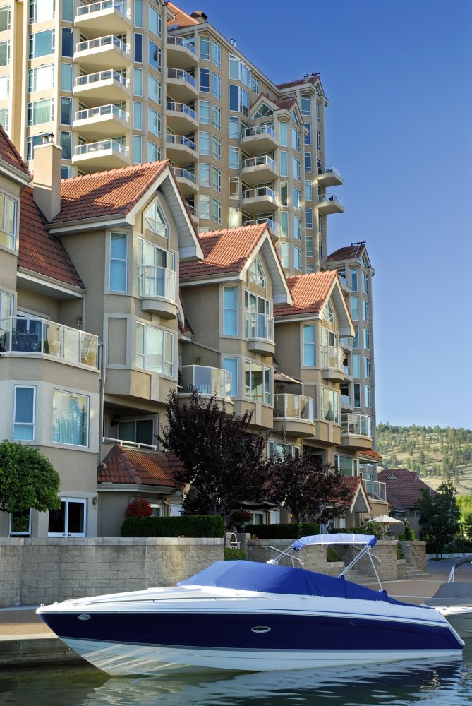 Waterfront condominiums by a small boat.