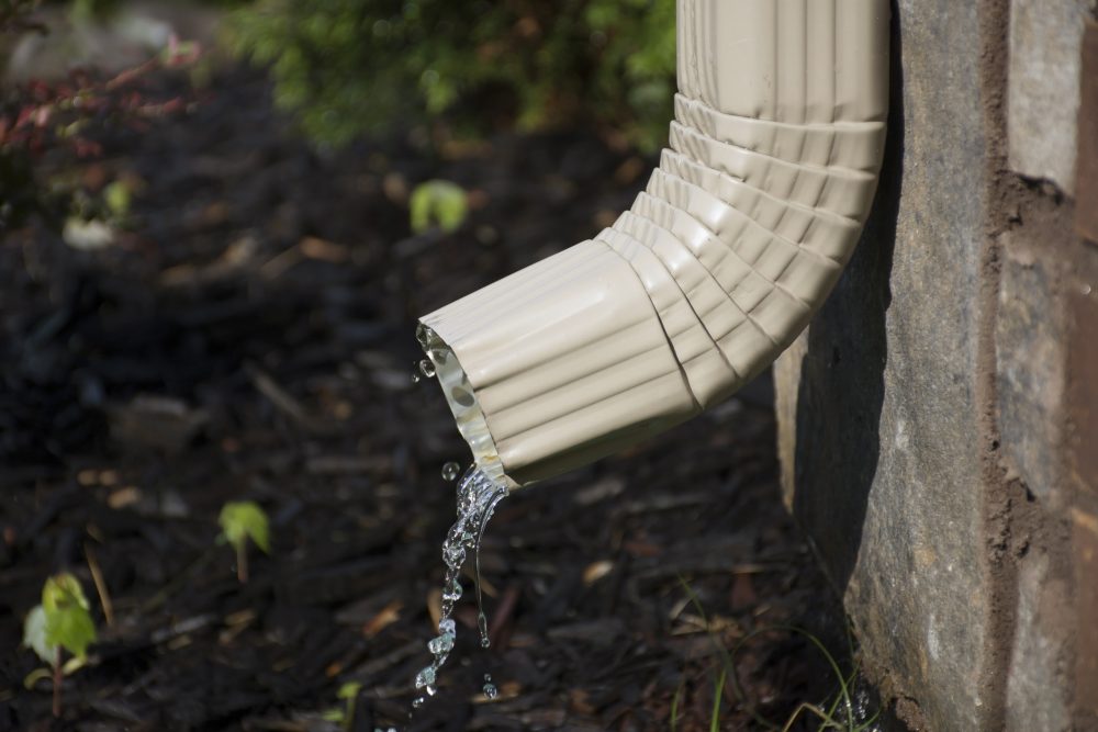 Gutter with downspout into garden