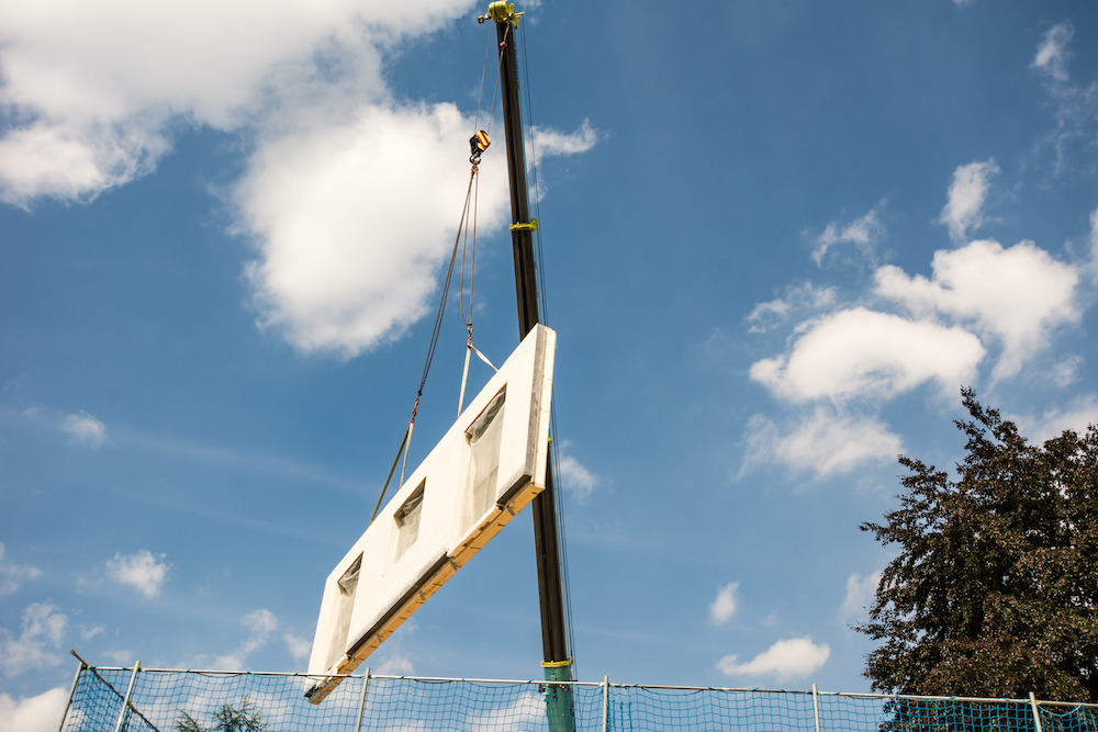 white prefabricated wall on crane