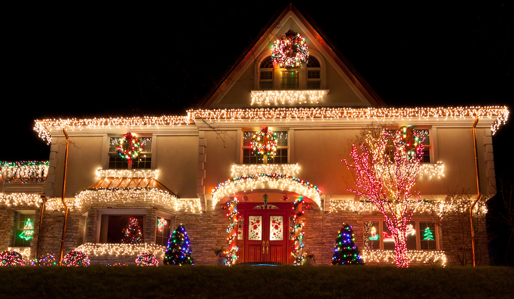 house with white icicle lights at roof and windows