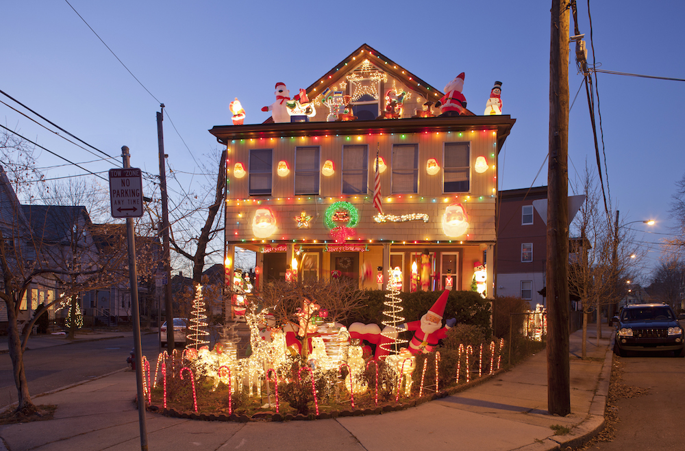 corner house with inflatable Christmas decorations on roof and lights