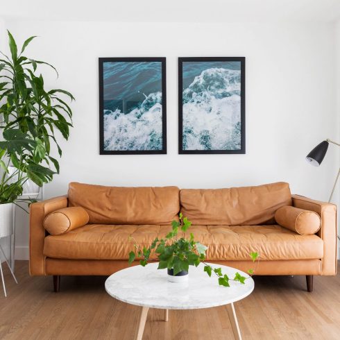 Photography artwork of water hanging over the couch in a basement living room