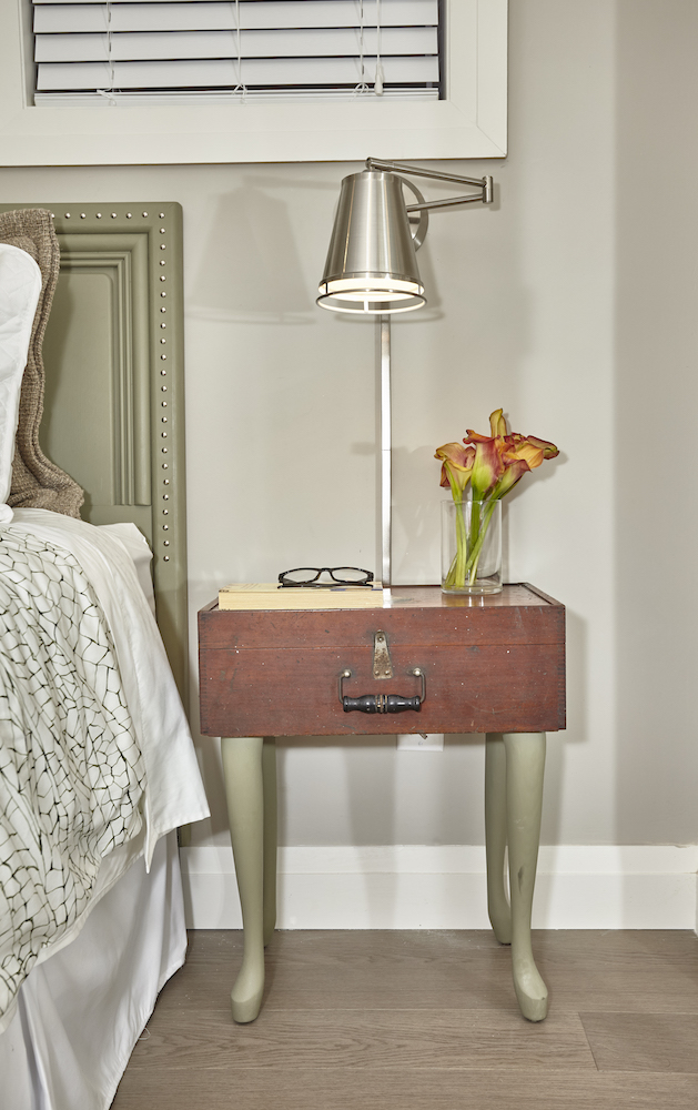 A quirky side table in a guest basement bedroom