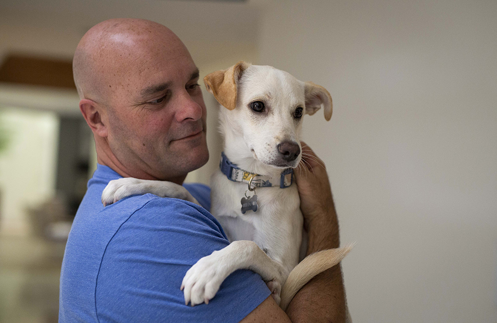 Bryan with their new dog Willow.