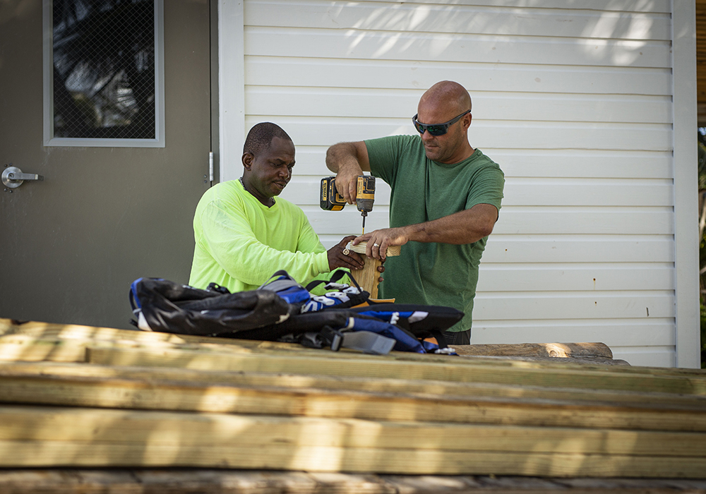 Bryan Baeumler on set of Island of Bryan doing carpentry work.