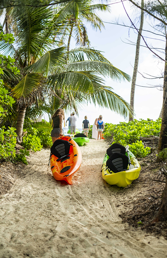 The Baeumler children head to the ocean with kayaks in tow.