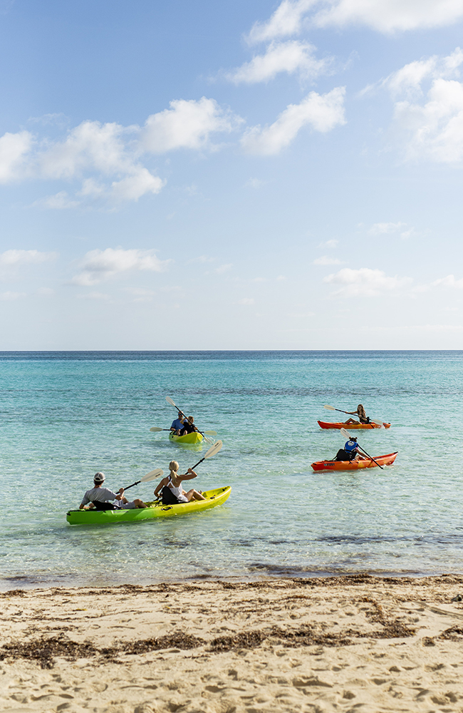 The Baeumler family out for a kayak ride on multi-coloured kayaks.