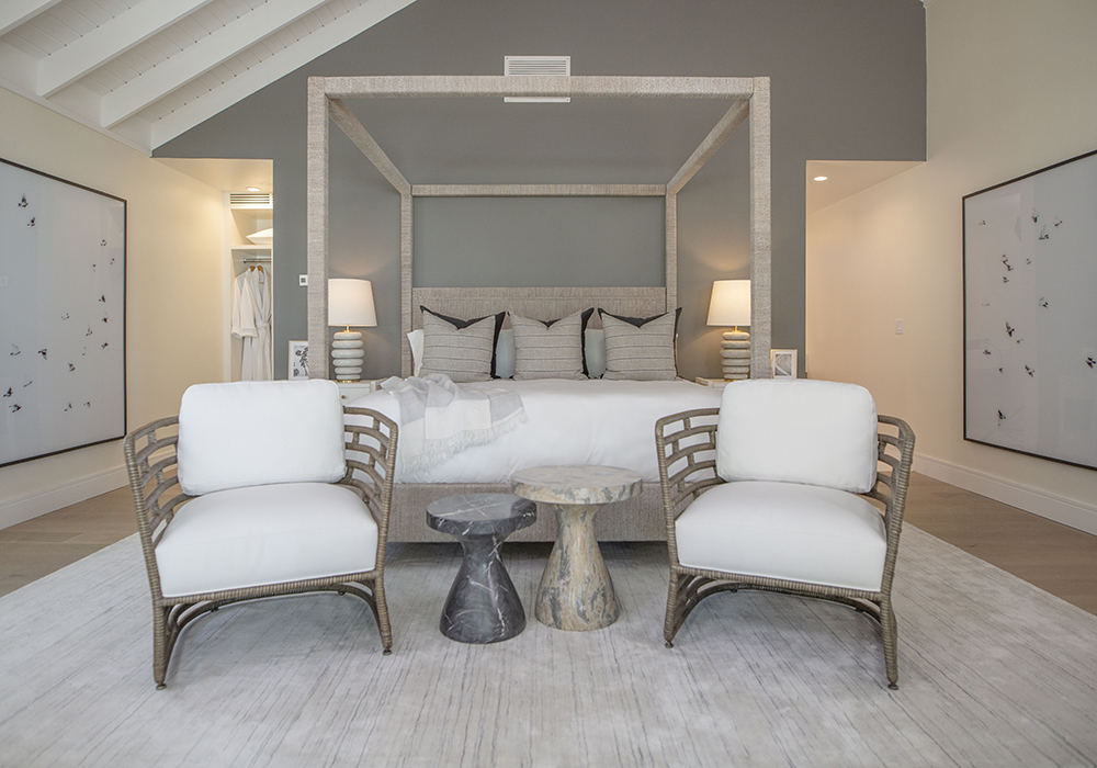 The interior of a villa on Island of Bryan. A bed, chairs and tables are placed in a decorative manner.