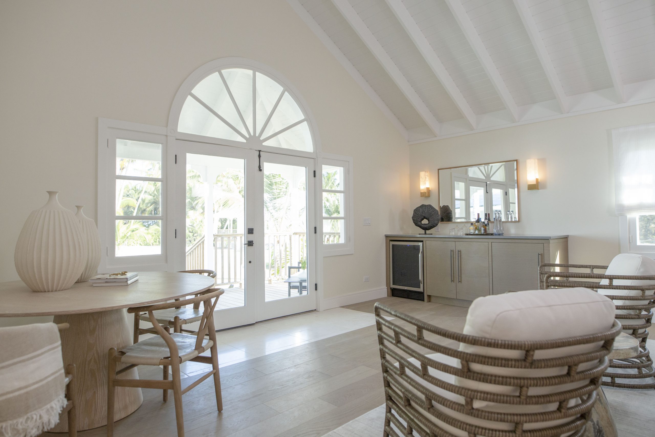 The interior of a villa on Island of Bryan with a bar fridge and casual seating.