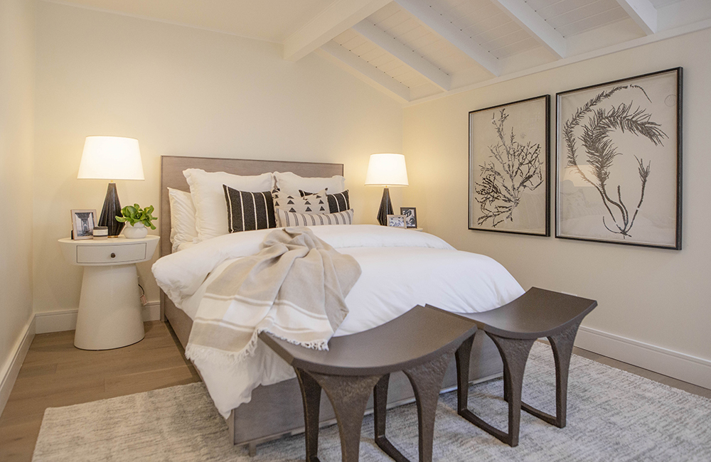 A queen-size bed in a beige hotel room on the Island of Bryan.