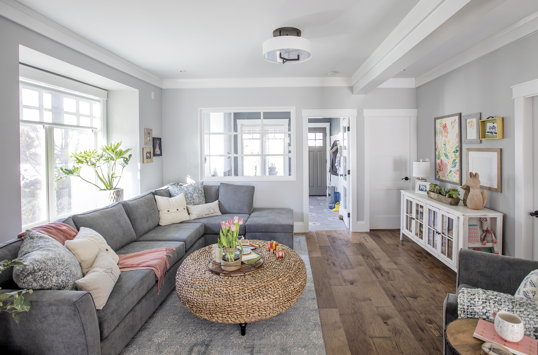 Soft grey living room with extra-large sectional and blush pink accents.