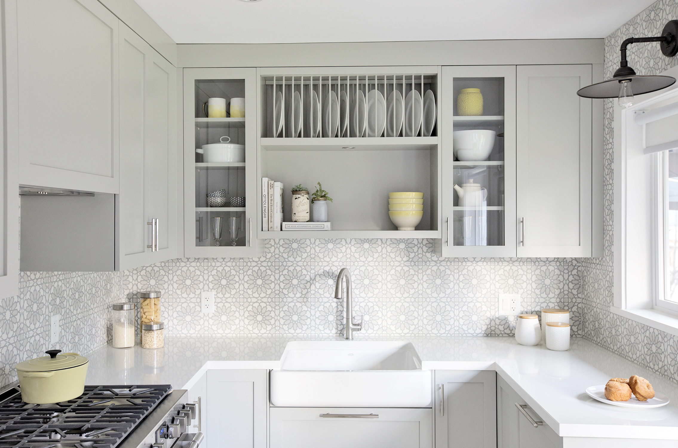 Neutral country-style kitchen with built-in plate racks and cabinetry storage.