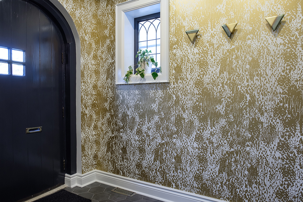 Gold wallpaper in the front hall of a home