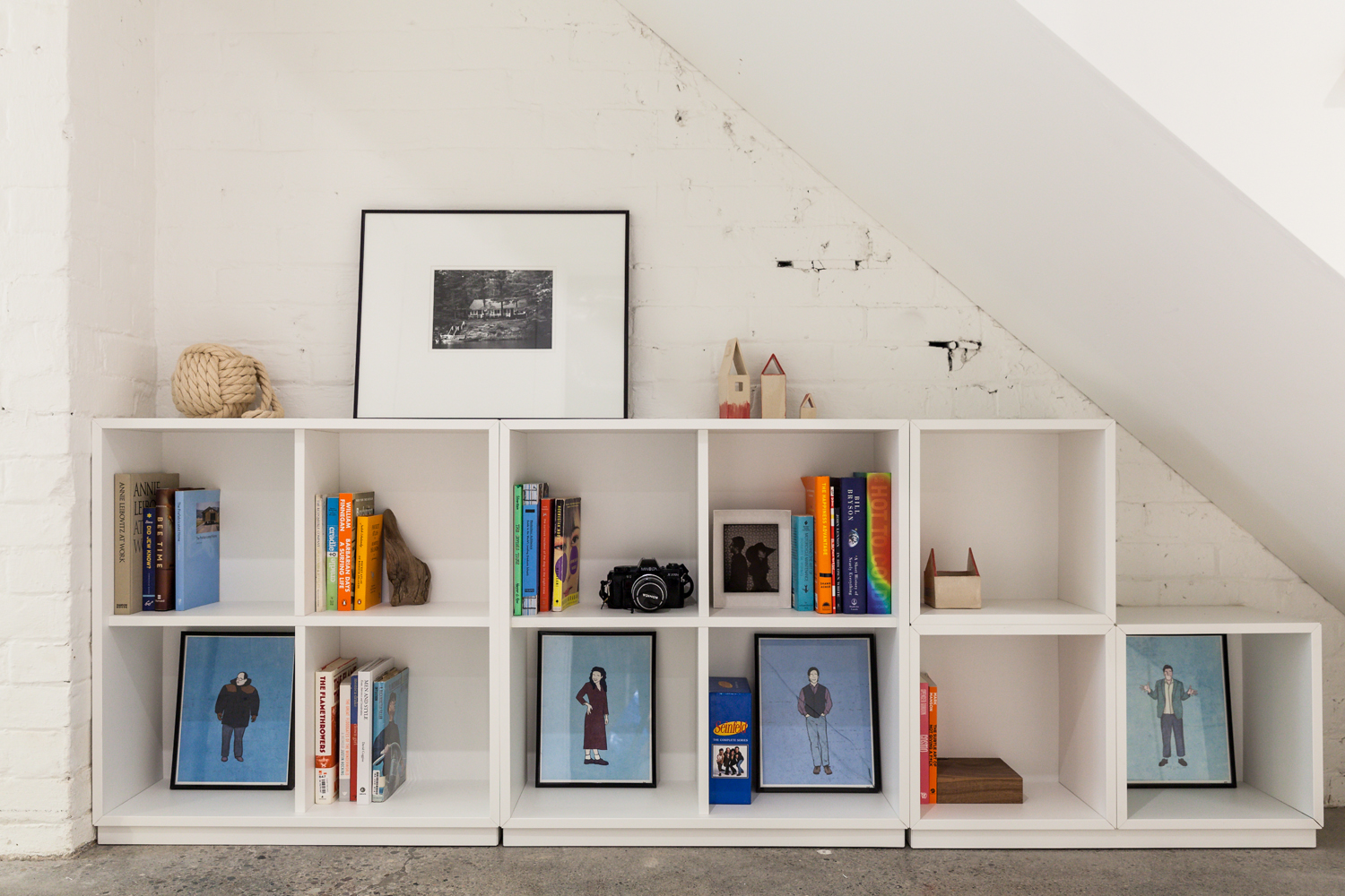 Bookshelf below the stairs in a basement