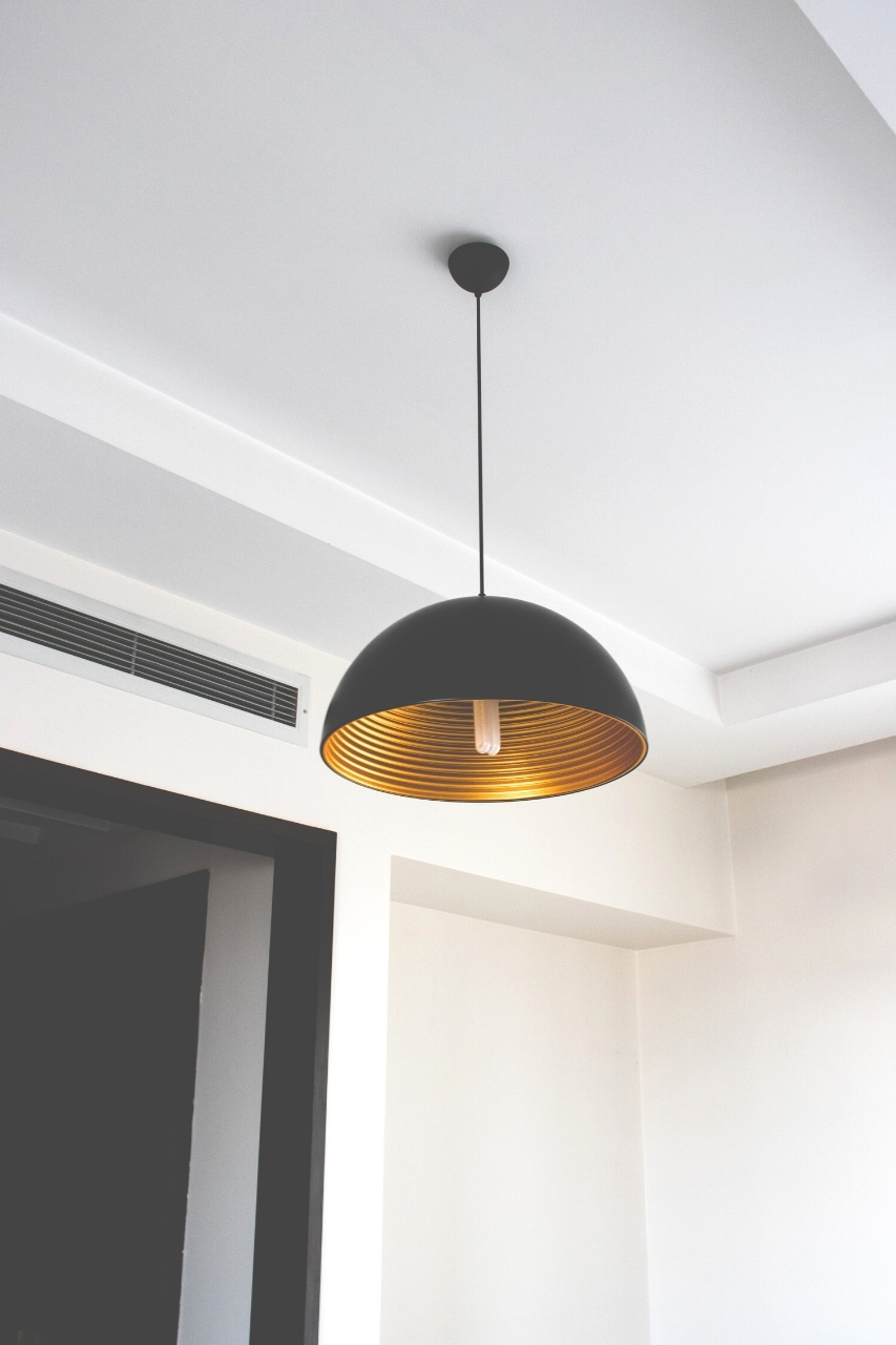 A matte black and gold light fixture.