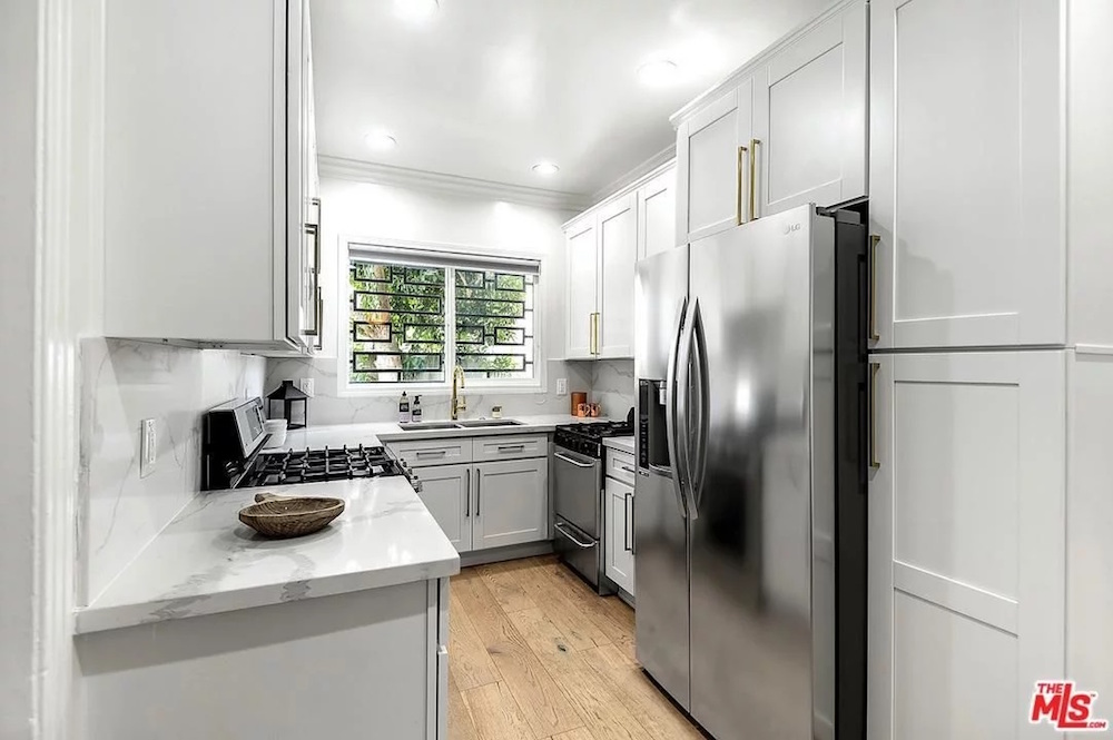 white kitchen with stainless steel appliances