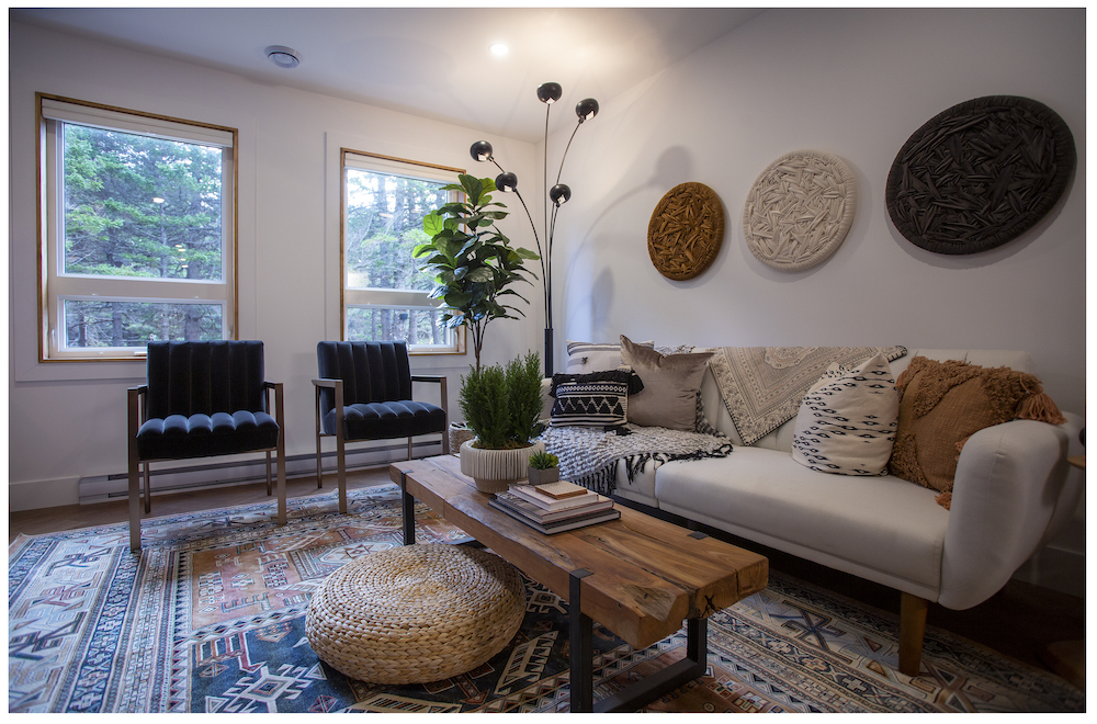 white living room with wood coffee table and patterned area rug