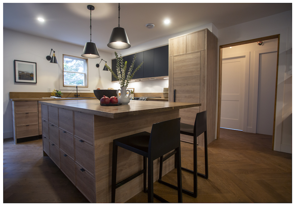 sleek wood kitchen with black upper cabinets and centre island