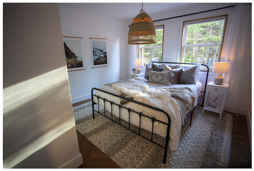 white bedroom with cozy white bed and two windows