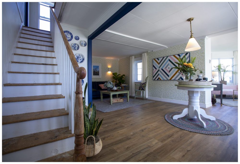 wooden staircase with view of open-concept living room