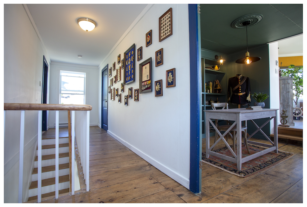 white landing with wood floorboards and gallery wall in hallways