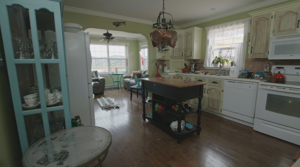 before kitchen with green walls and white appliances