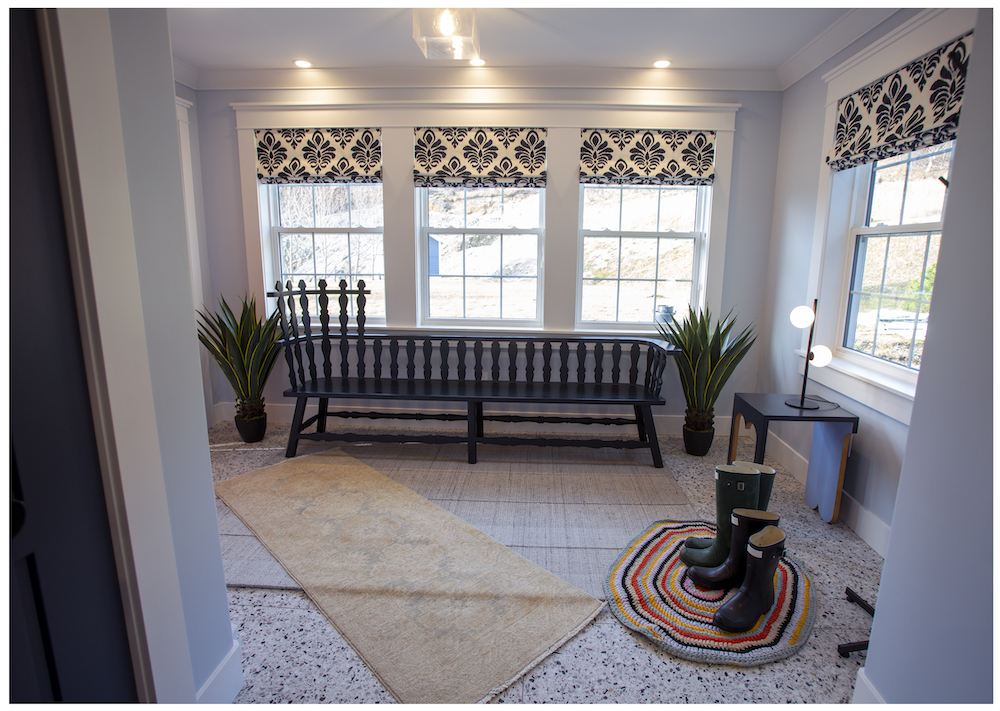 bright white mudroom with windows and bench