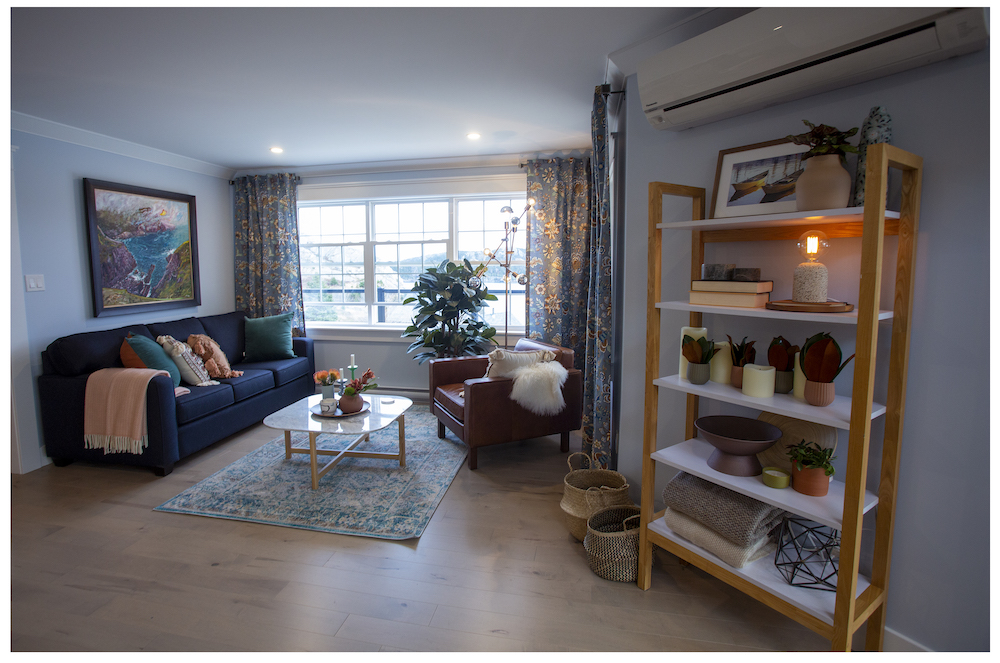 cozy sitting room with blue couch and patterned area rug