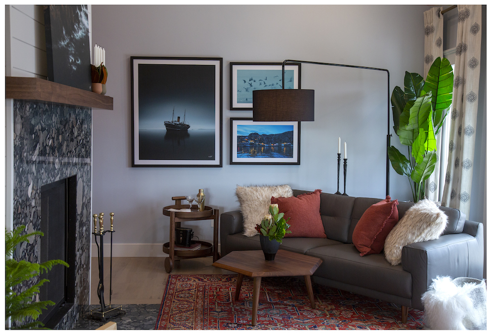 cozy living room with granite fireplace and grey couch