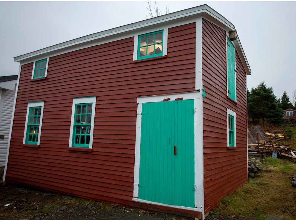 new red barn with bright green door and windows