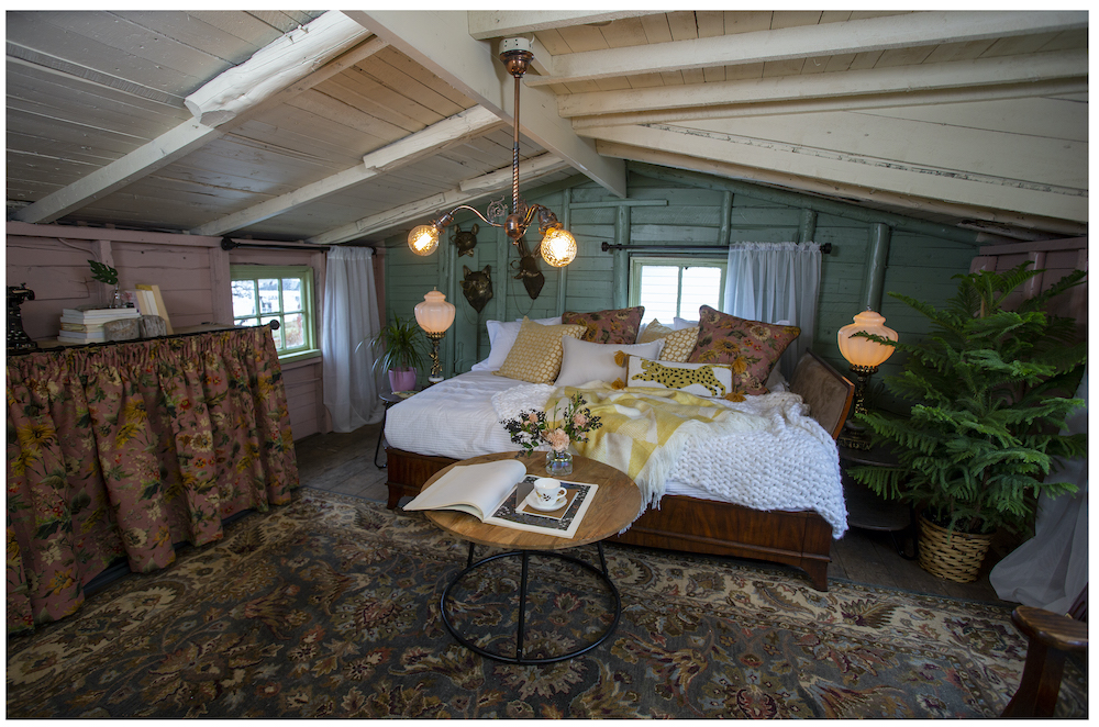 loft space with white daybed and green accent wall