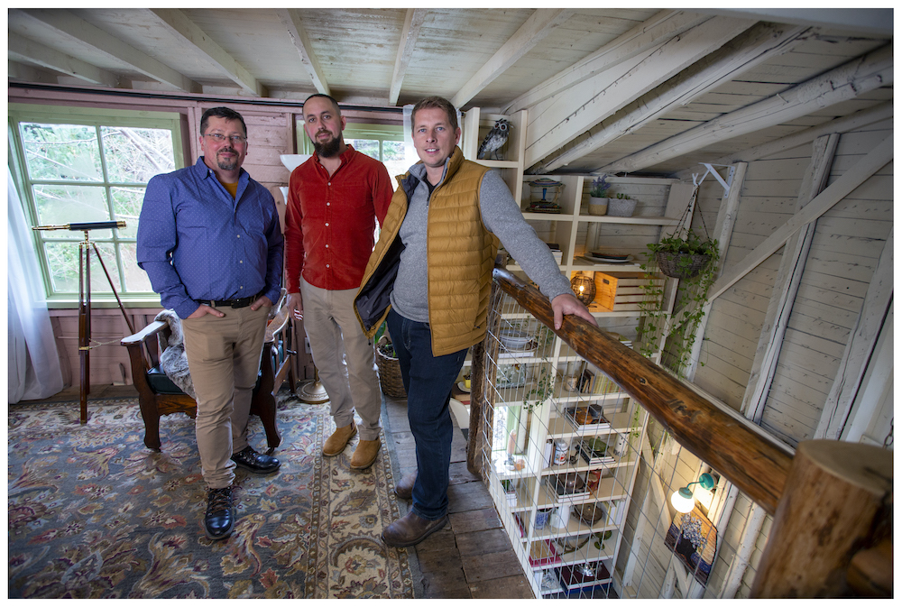 homeowners Cory and Leo stand with Randy at the top of the barn loft