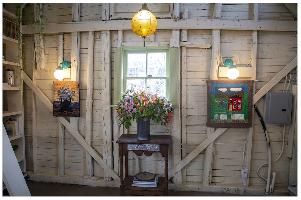 wooden interior wall of barn with small green-framed window