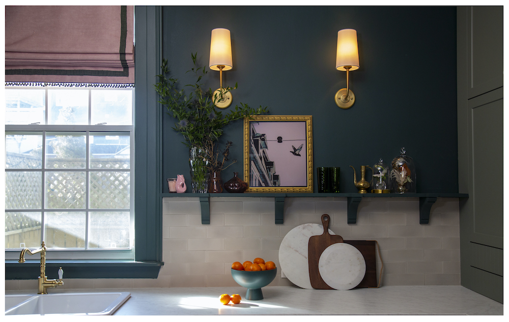 kitchen counter with concrete-brick backsplash and brass wall sconces